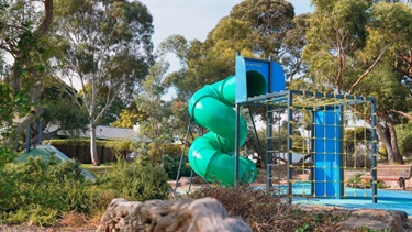 Play area for kids to have fun including a swirling slide